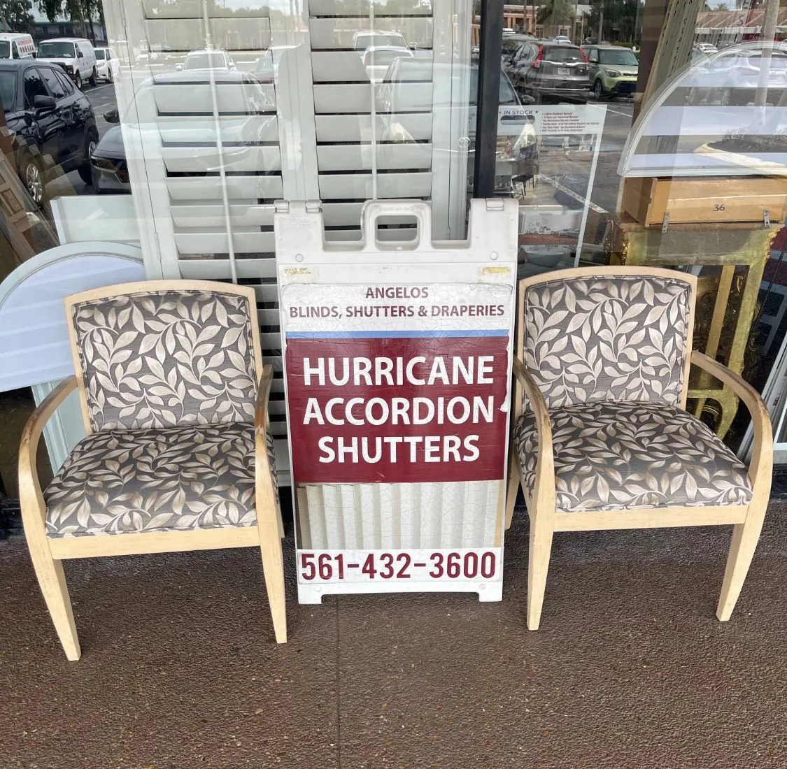 Angelo's hurricane accordion shutters sign outside the showroom