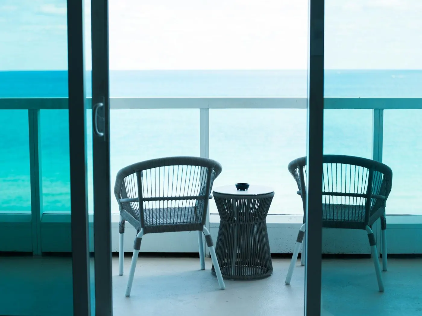 Sliding glass doors opening onto an ocean-view balcony